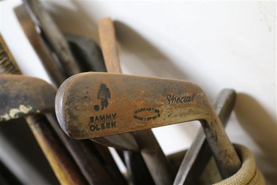 Two wooden drivers by Armstrong & Co and Paxton, a gun metal putto signed Jacques, 7 other and a golf ball